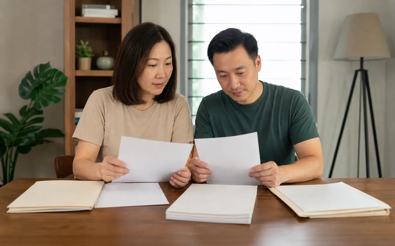 Chinese Malaysian couple reviewing permit and employment requirements